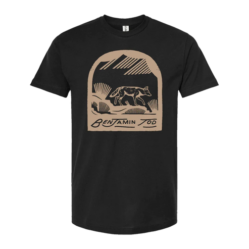 Coyote graphic printed in tan on the front of a black tee with Benjamin Tod text