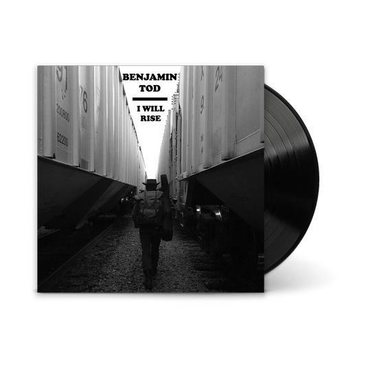 Vinyl record album cover for 'I Will Rise' by Benjamin Todd, featuring a black and white photo of him walking between train cars, with the black record partially visible on the right